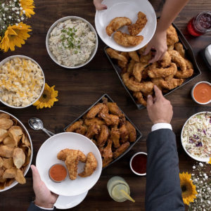 Slim Chickens Wedding Catering with tenders, coleslaw, wings, chips, and sauces