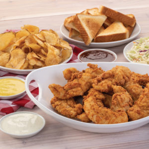 Slim Chickens picnic pack with tenders, chips, toast, coleslaw, and sauces